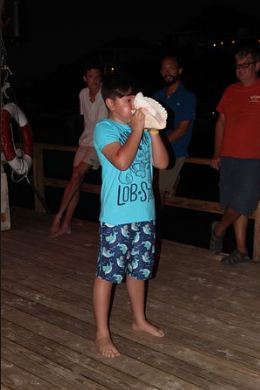 Kid blowing conch shell